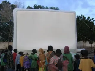 Crowd gathered in front of a Hallucine inflatable cinema screen in Djibouti, just before the start of the screening