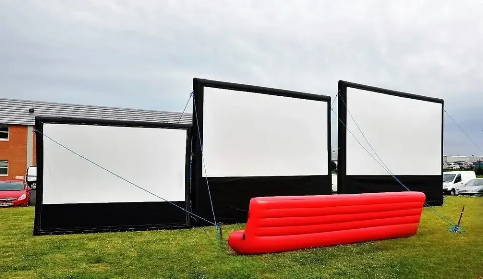 Three Hallucine inflatable screens with red inflatable sofa